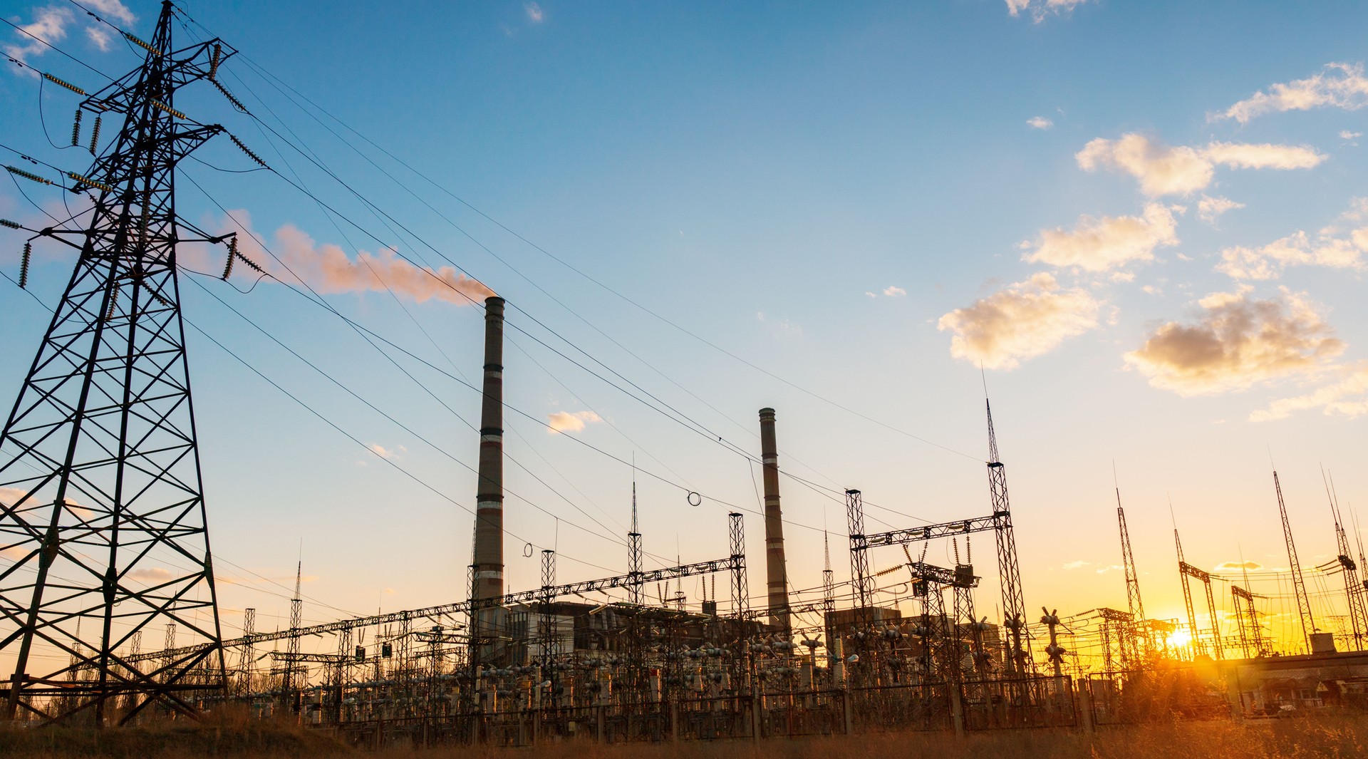 Thermal power stations and power lines during sunset.